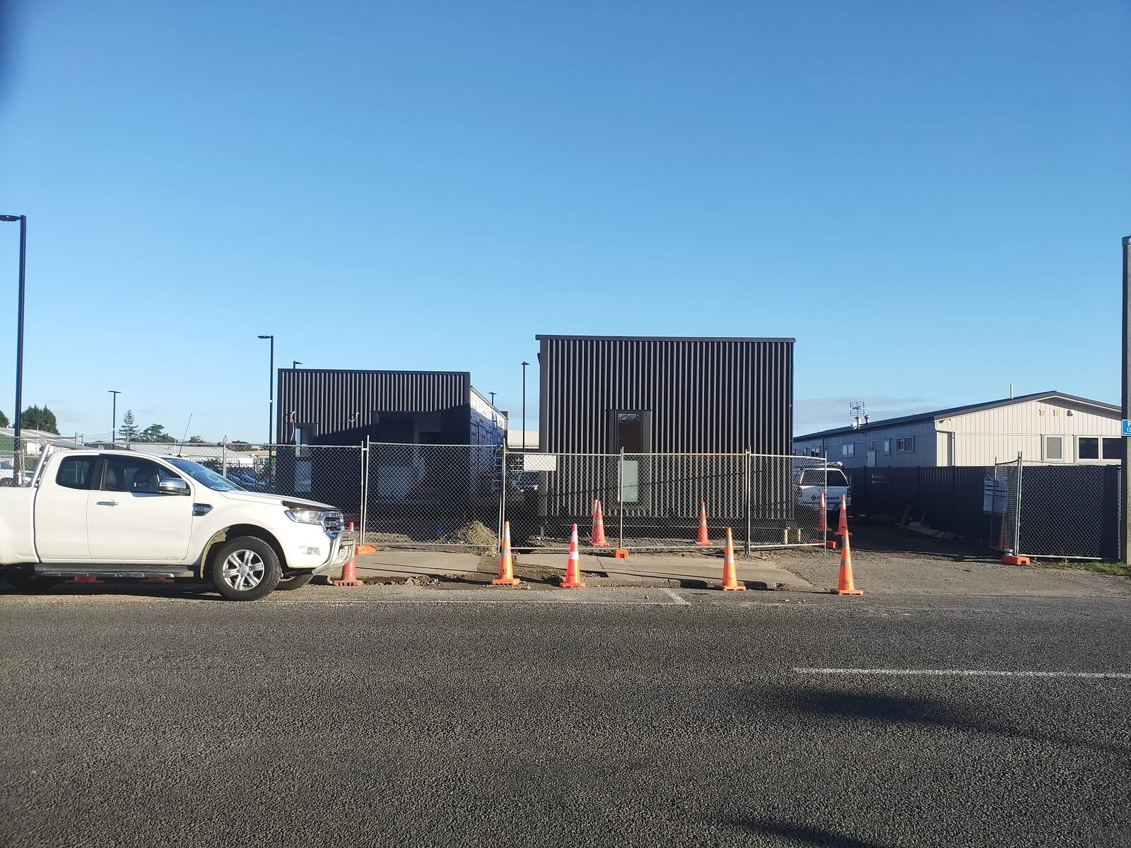 The joined modules seen from Canning Road with their dark corrugated cladding installed